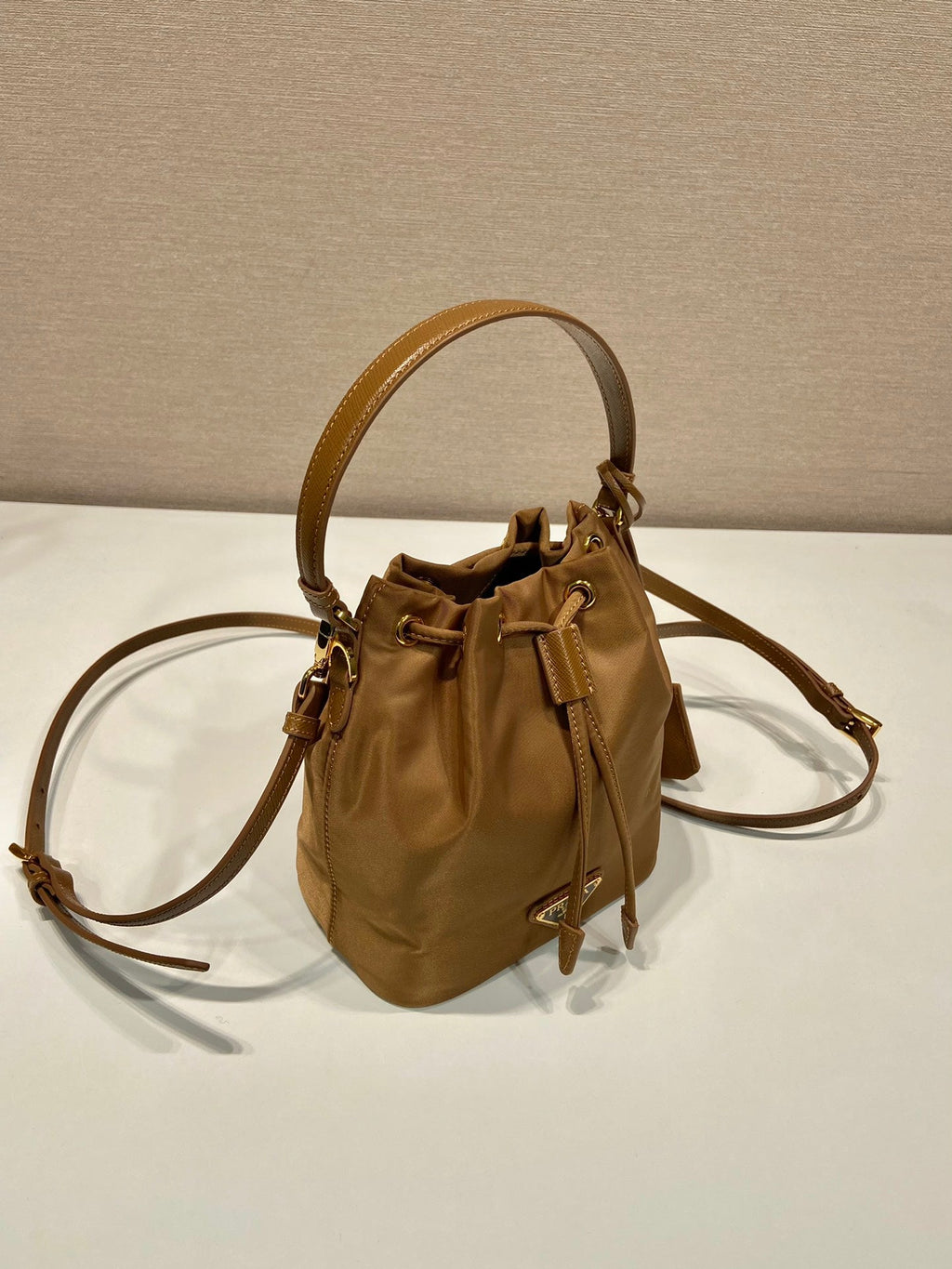 BUCKET BAG 19 IN RUSSET BROWN RE-NYLON AND CALFSKIN HANDLE