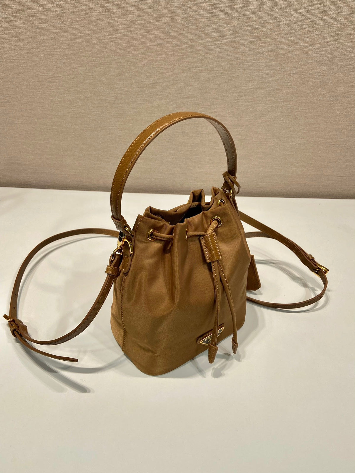 BUCKET BAG 19 IN RUSSET BROWN RE-NYLON AND CALFSKIN HANDLE