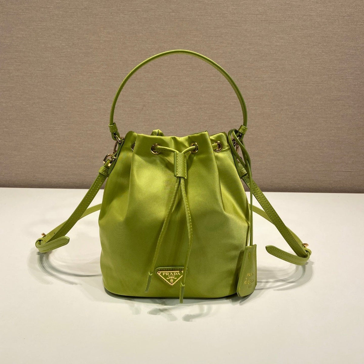 BUCKET BAG 19 IN APPLE GREEN RE-NYLON AND SAFFIANO LEATHER HANDLE