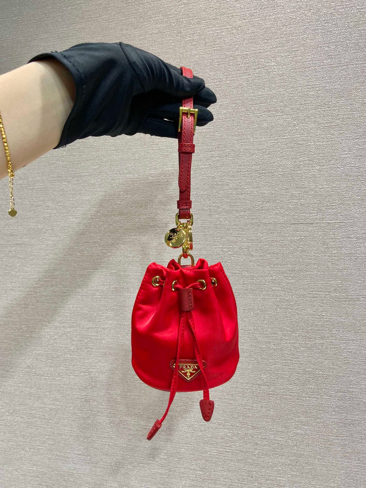 MINI BUCKET BAG 10 IN RED RE-NYLON AND SAFFIANO LEATHER STRAP