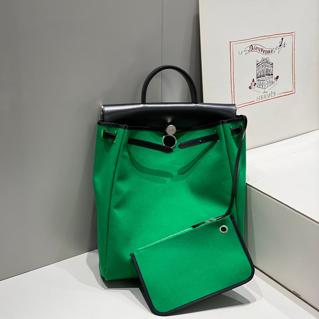 HERBAG A DOS ZIP RETOURNE BACKPACK 29 IN GREEN CANVAS AND BLACK CALFSKIN
