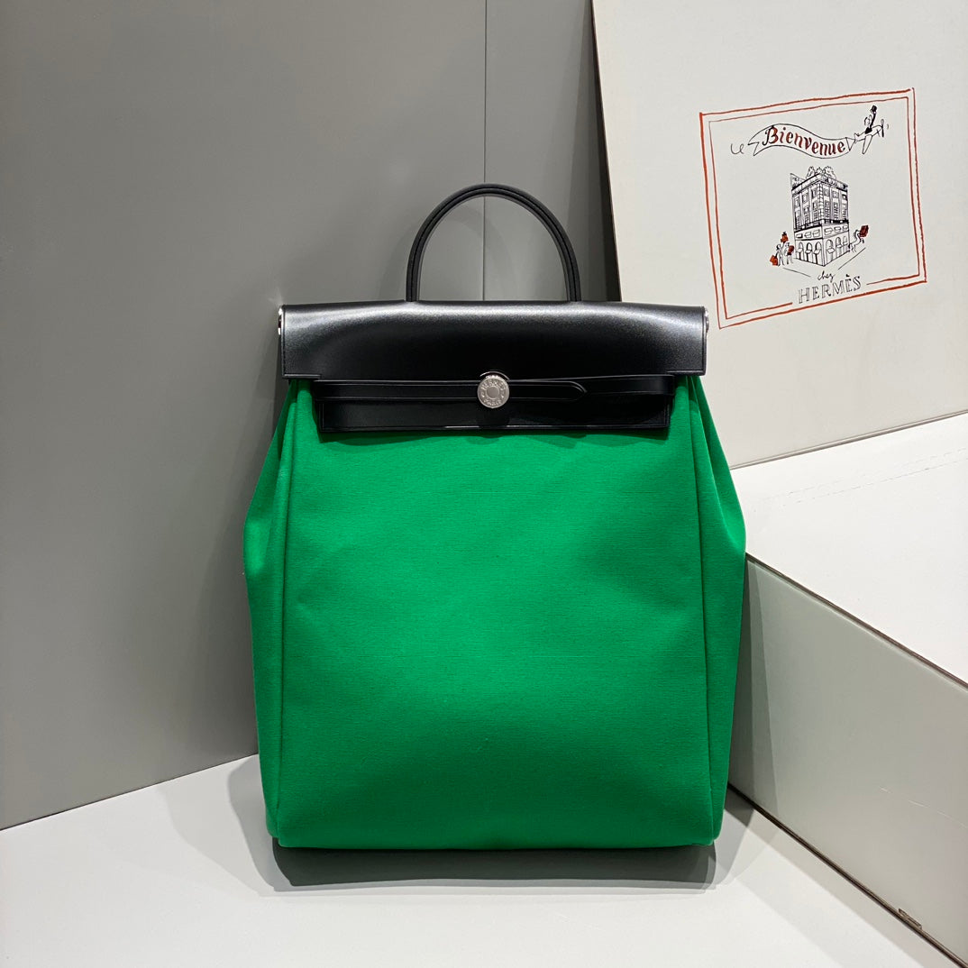 HERBAG A DOS ZIP RETOURNE BACKPACK 29 IN GREEN CANVAS AND BLACK CALFSKIN