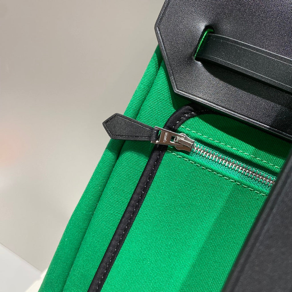 HERBAG A DOS ZIP RETOURNE BACKPACK 29 IN GREEN CANVAS AND BLACK CALFSKIN